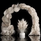 Wedding arch made of dry palm branches and pampas grass